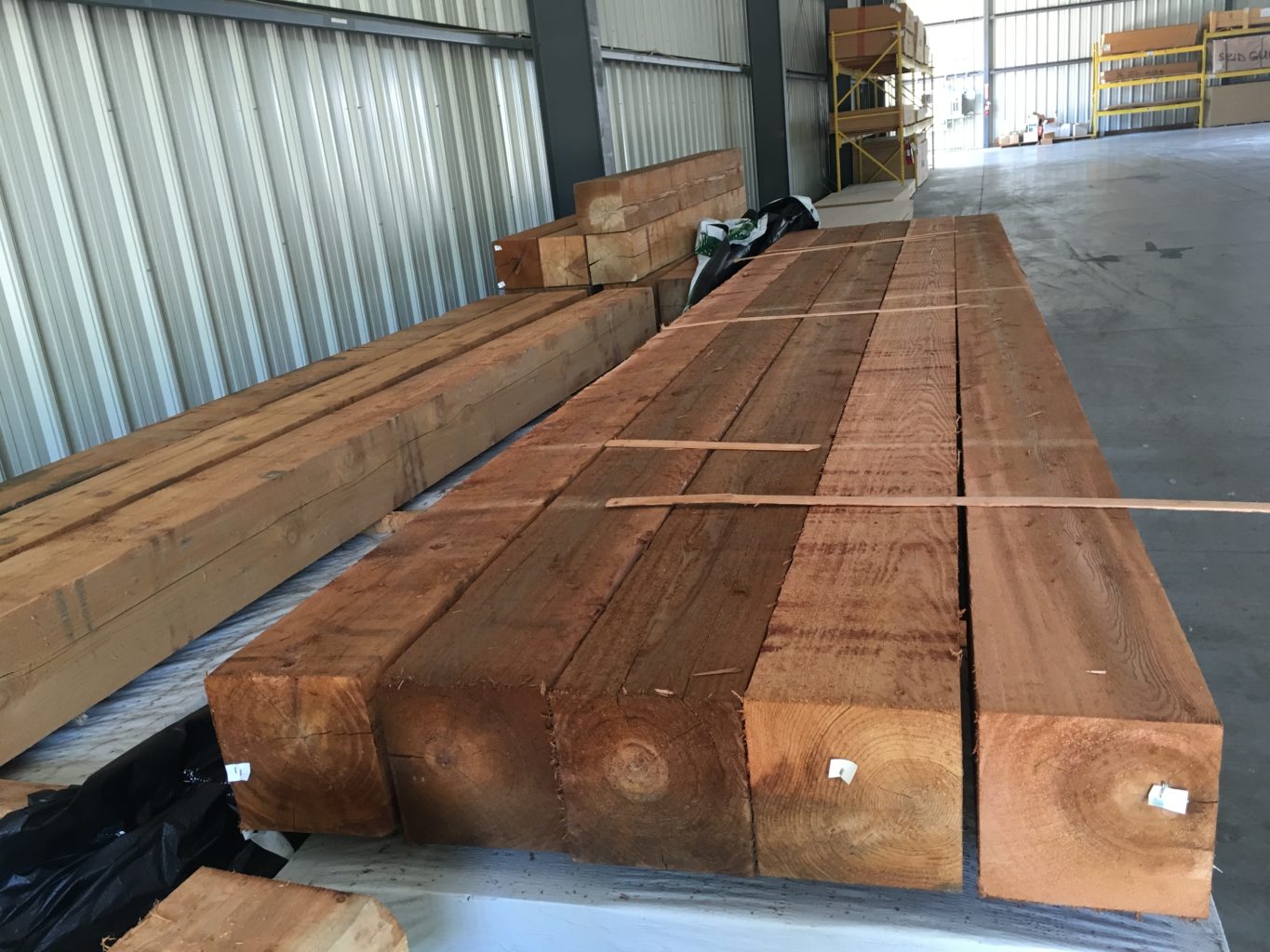 Stacked wooden beams in a warehouse.