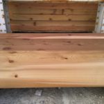 Wooden bench with a natural finish and visible grain patterns.