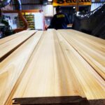 Smooth wooden planks neatly arranged in a workshop.