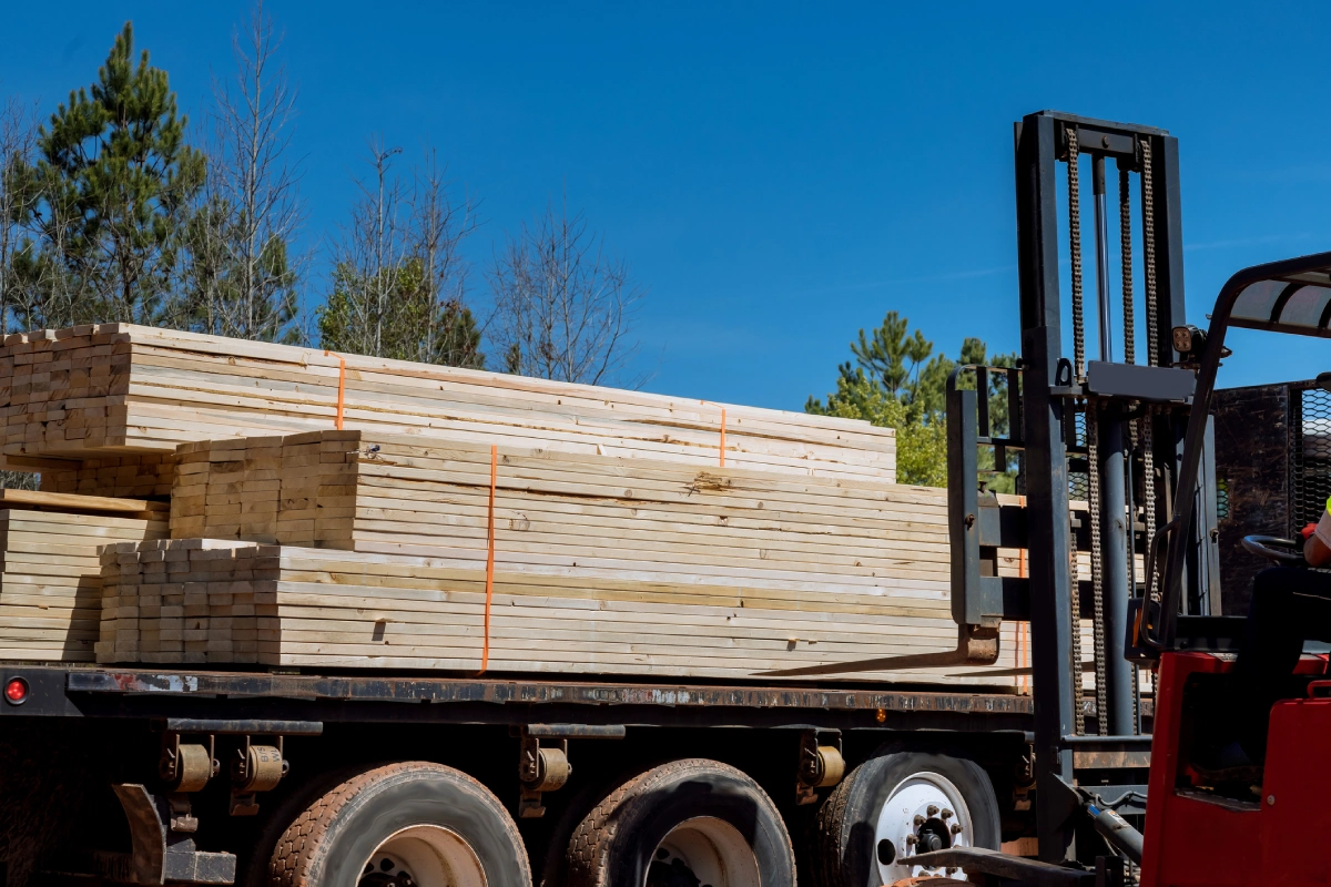 Forklift loading lumber onto truck